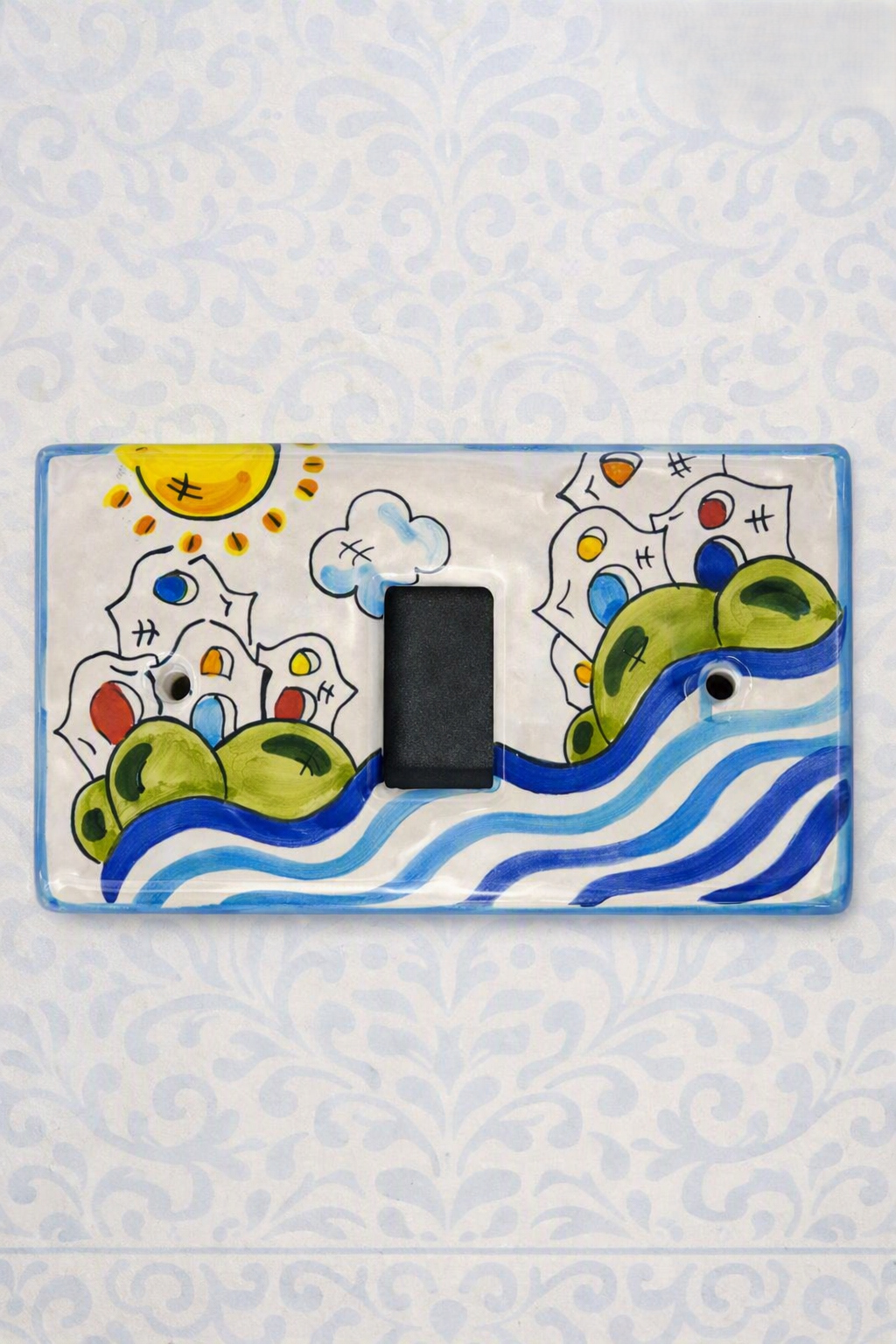 placca copri interruttore in ceramica decorata a mano, modello magic ticino, artigianato made in italy